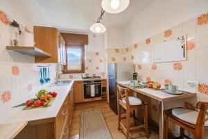 a kitchen with a counter with fruits and vegetables on it at Casa Alexander - Lake Garda Apartment with Terrace - Happy Rentals in Riva del Garda