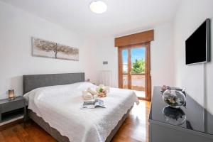 a bedroom with a bed with a fish bowl on it at Casa Alexander - Lake Garda Apartment with Terrace - Happy Rentals in Riva del Garda