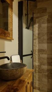 a bathroom with a large stone sink on a wooden counter at Casa Rural Doña Aba in Espinosa de los Monteros