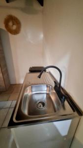 a stainless steel sink in a corner of a kitchen at Green Point Nosara in Nosara