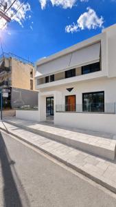 a white building on the side of a street at Andromeda Suite Private Jacuzzi & Cave Shower in Athens