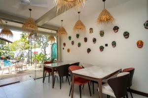 a restaurant with tables and chairs and masks on the wall at I Ahangama - 100m to Kabalana Beach in Ahangama