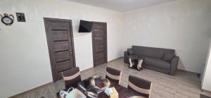 a living room with a couch and a table and chairs at Hasmik house in Areni