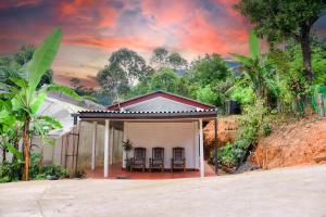 a small house on the side of a road at Misty Peaks Villa in Haldummulla