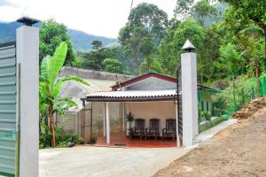a house with a view of the back yard at Misty Peaks Villa in Haldummulla +4 photos