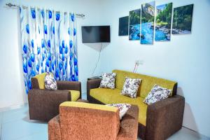 a living room with two couches and a tv at Misty Peaks Villa in Haldummulla