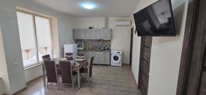 a kitchen and dining room with a table and a television at Hasmik house in Areni +5 photos