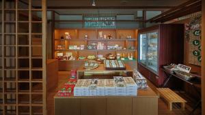 a store with a counter with books on it at かっぱの宿旅館三治郎 in Zao