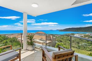 a balcony with a view of the ocean at Searene By The Sea in Airlie Beach