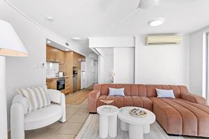a living room with a couch and a table at Searene By The Sea in Airlie Beach