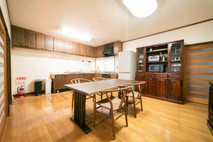 a kitchen with a table and chairs in a room at Morioka base モリオカベース in Morioka