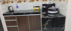 a kitchen with a counter with a coffee maker on it at Jaya's Homestay in Simpang Ampat