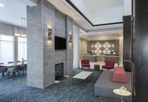 a lobby with a fireplace and a dining room at Hilton Garden Inn Raleigh Cary in Cary