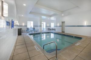 a large swimming pool in a building at Hilton Garden Inn Raleigh Cary in Cary