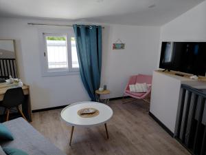 a living room with a couch and a table at Papaya in Noumea