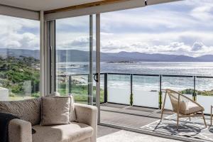 a living room with a view of the ocean at Elevation in Bicheno