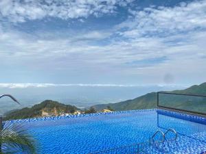 a swimming pool with a view of a mountain at Time Villa in Tam Ðảo