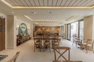 a dining room with tables and chairs in a restaurant at Là Thông Boutique Đà Lạt in Da Lat