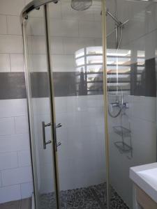 a shower with a glass door in a bathroom at Papaya in Noumea
