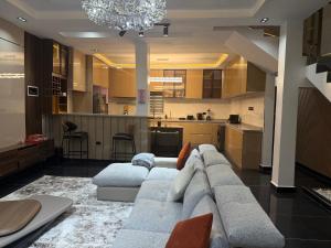 a living room with a couch and a kitchen at House 9 Signature in Port Harcourt