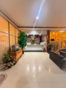 eine Lobby eines Gebäudes mit Sofas und Pflanzen in der Unterkunft arafah hotel in Sungaipenuh