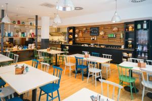 a restaurant with tables and chairs and a counter at Vienna House Easy by Wyndham Neckarsulm in Neckarsulm +56 photos