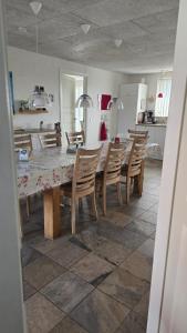 a kitchen with a dining room table and chairs at Sov Godt i Arnborg Bed & Breakfast in Arnborg