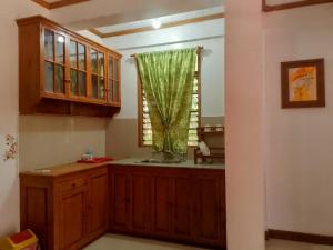 a kitchen with a sink and a window at REKWOOD Hotel in Boracay +49 photos