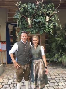 a man and a woman posing for a picture in front of a christmasreath at Hotel-Restaurant Dechbettener Hof in Regensburg