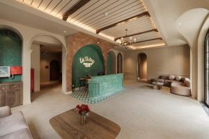 a lobby with a waiting room with a couch and a table at Là Thông Boutique Đà Lạt in Da Lat