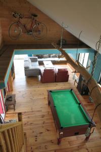 a living room with a pool table and a bicycle at Le Chalet de Merlimont in Merlimont