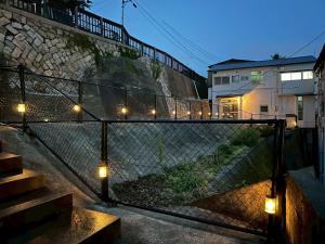 a set of stairs with lights on a fence at インジホテル下関 in Shimonoseki
