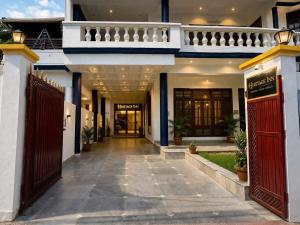 a hallway of a house with red doors and a gate at Heritage Inn in Lucknow