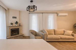 a living room with a couch and a fireplace at Villa Kumsal in Kuşadası