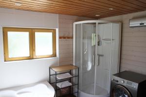 a bathroom with a shower and a washing machine at Le Chalet de Merlimont in Merlimont +45 photos