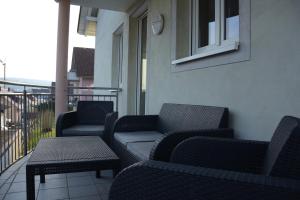 a balcony with chairs and a couch and a table at Ferienwohnung Südwind 2 in Hohentengen
