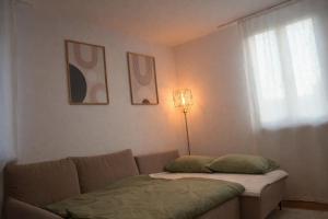 a living room with a couch and a window at Ferienwohnung Südwind 2 in Hohentengen