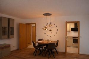 a kitchen and dining room with a table and chairs at Ferienwohnung Südwind 2 in Hohentengen