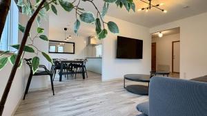 a living room with a couch and a table at Ts House Hakodate Park Front in Hakodate