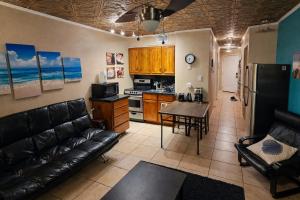 a living room with a couch and a table and a kitchen at The Sandbar Stay - North Beach Waterfront Condo in Corpus Christi