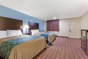 a hotel room with two beds and a television at Econo Lodge Woodstock - Shenandoah Valley I-81 in Woodstock +23 photos