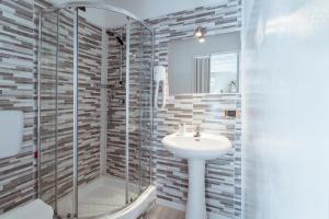 a bathroom with a sink and a shower at La Piccola Matilde in Desenzano del Garda