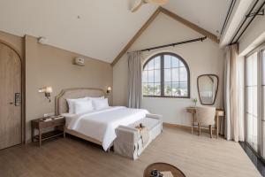 a bedroom with a large bed and a large window at Là Thông Boutique Đà Lạt in Da Lat +61 photos