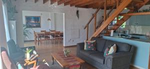 a living room with a couch and a table at White lily in Montagu