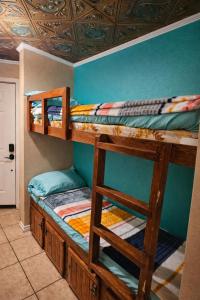two bunk beds in a room with a blue wall at The Sandbar Stay - North Beach Waterfront Condo in Corpus Christi +27 photos