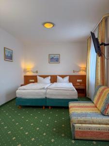 a hotel room with a bed and a couch at Hotel-Restaurant Dechbettener Hof in Regensburg +37 photos