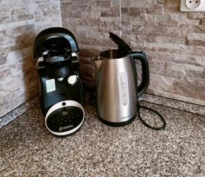 a coffeemaker and a coffee pot on a counter at Apartmán Simi, Karlovice 251, 79323 Karlovice in Karlovice