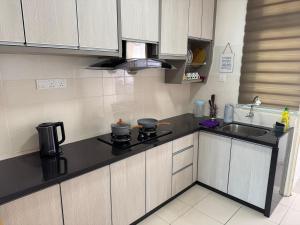 a kitchen with a stove and a sink at Spice Tunas 3B2B House in Bayan Lepas