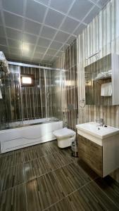 a bathroom with a tub and a toilet and a sink at seyir yeri otel cafe&restorant in Trabzon