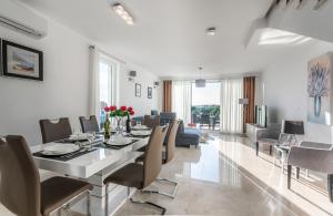 a dining room with a long table and chairs at Villa Toma in Milna